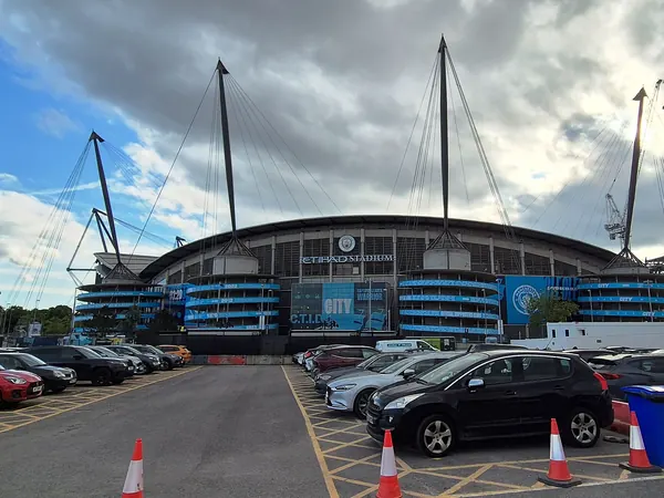 The Etihad Stadium with its mast-supported roof on the Etihad Campus, East Manchester