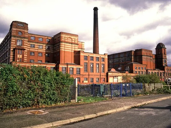 Leigh Spinners Mill with its striped brick facade and chimney in Leigh