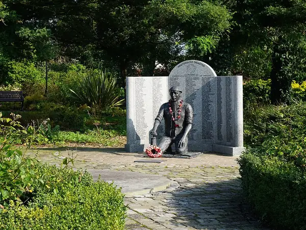 Pretoria Pit disaster memorial with a kneeling miner statue and walls of names, Westhoughton