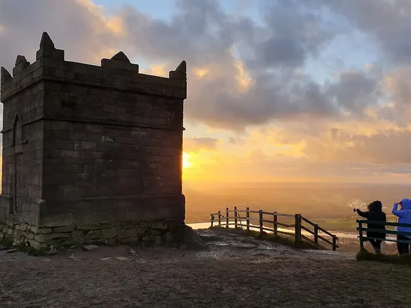 The stone tower on the summit of Rivington Pike above Horwich at sunset